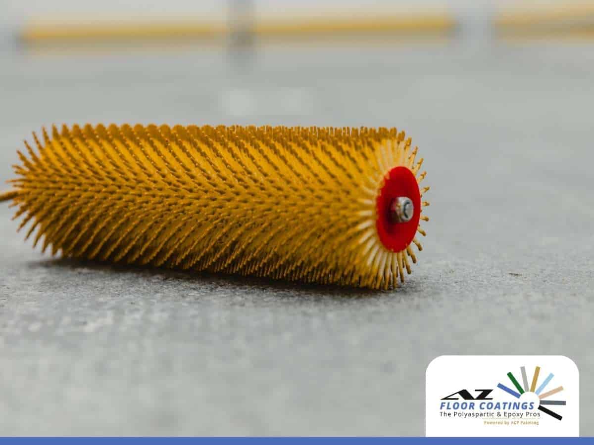 Yellow spike roller used for polyaspartic coatings application on concrete floor by AZ Floor Coatings